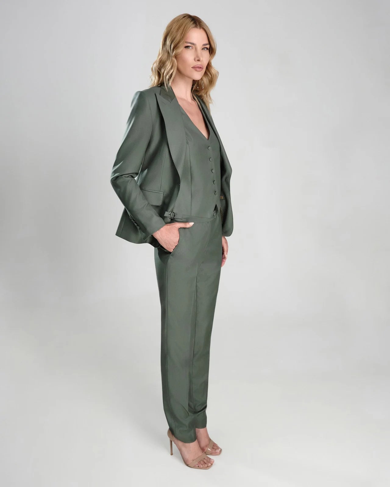 A green Consiglieri DONNA women’s three-piece suit with a waistcoat and tapered trousers