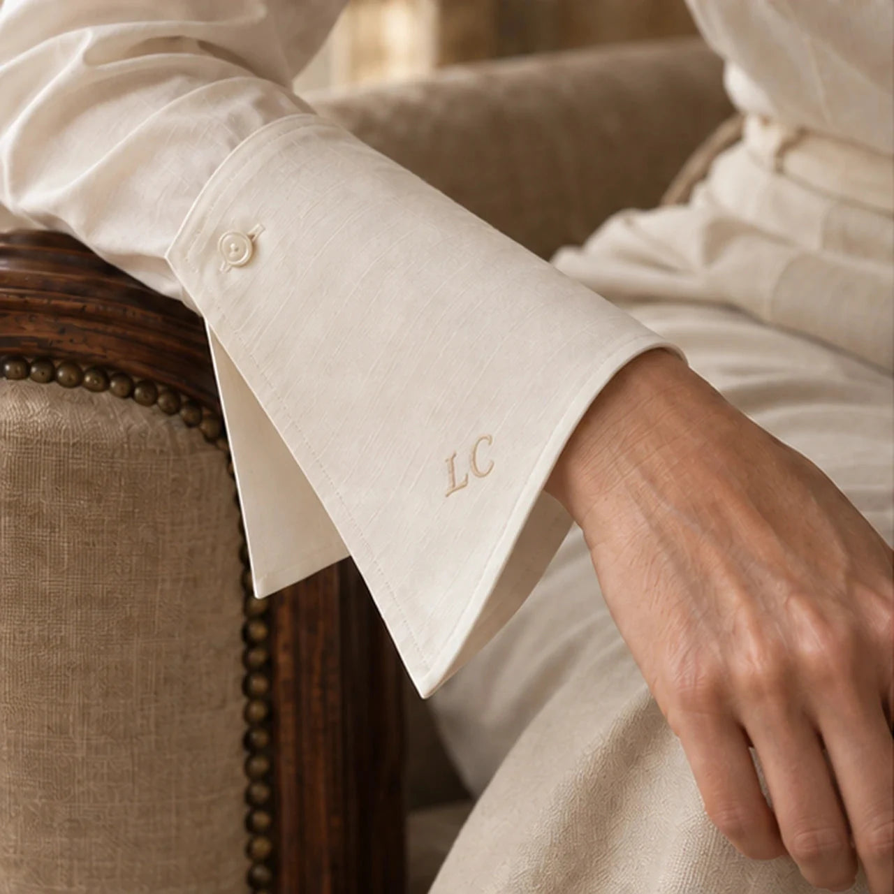 Detail of the shaped ivory cuff and embroidered LC initials.